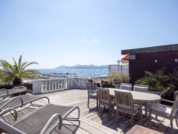 Wooden terrace with garden furniture and sea view in Cannes.