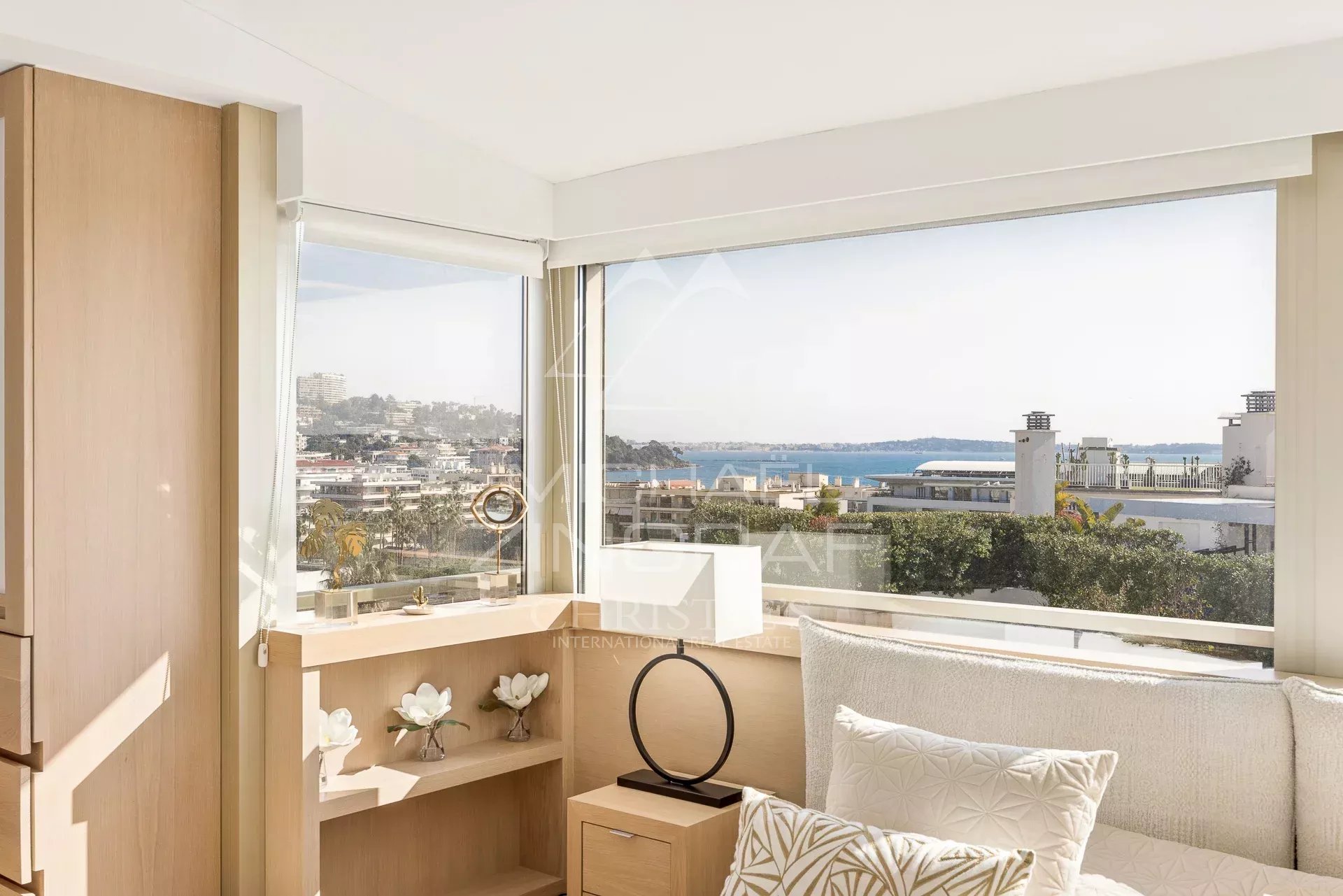 Intérieur lumineux d'un penthouse à Cannes avec vue sur la mer et les îles de Lérins.
