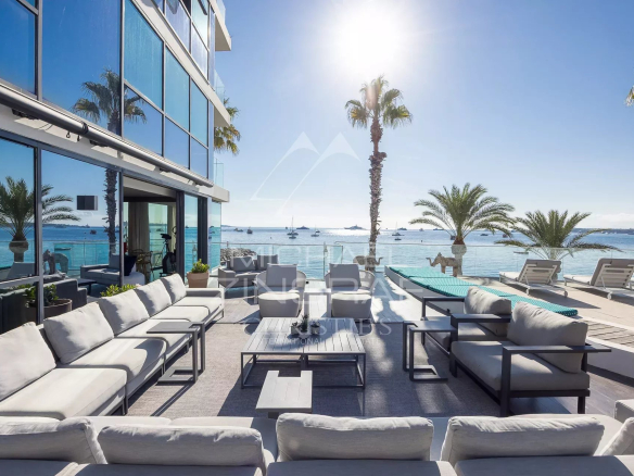 Terrasse d'un triplex en front de mer à Cannes avec vue sur la mer et les palmiers.