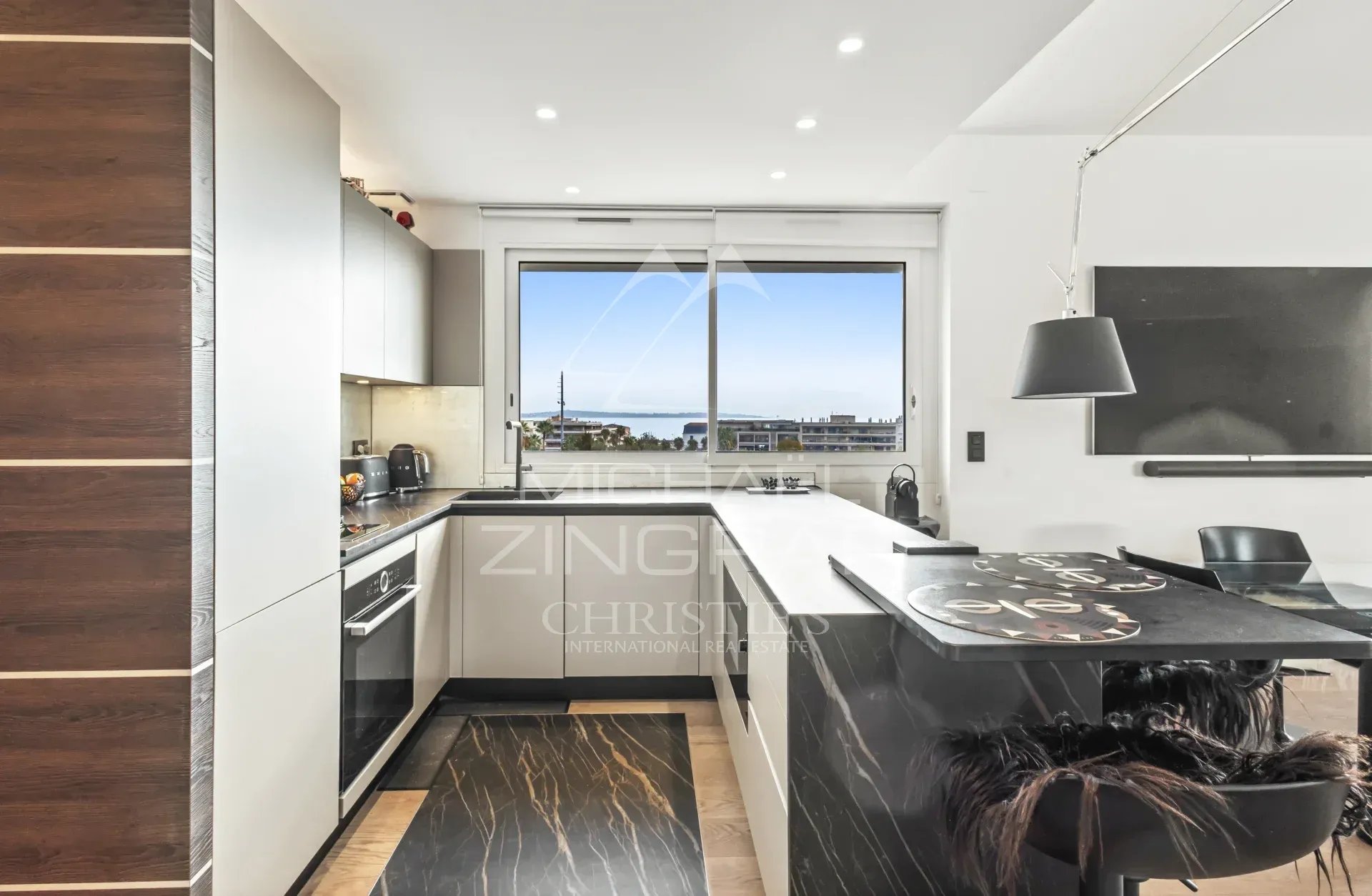 Cuisine d’un appartement rénové à Cannes Cuisine moderne avec vue sur la mer, appartement rénové à Cannes.