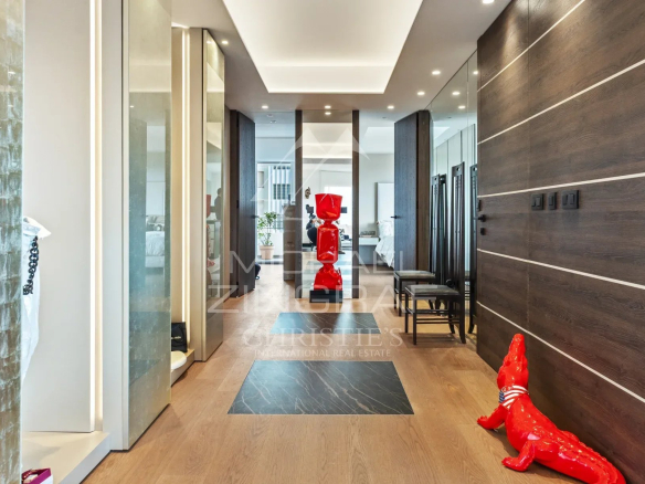 Hall d'entrée d'un appartement rénové à Cannes avec décoration moderne et sculptures.