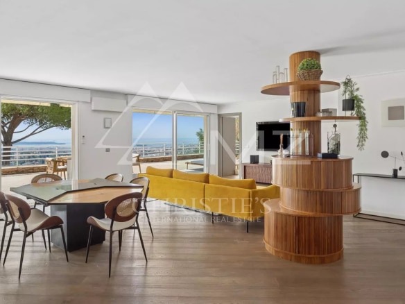 Interior of a modern apartment with sea view, bright living room and spacious terrace.