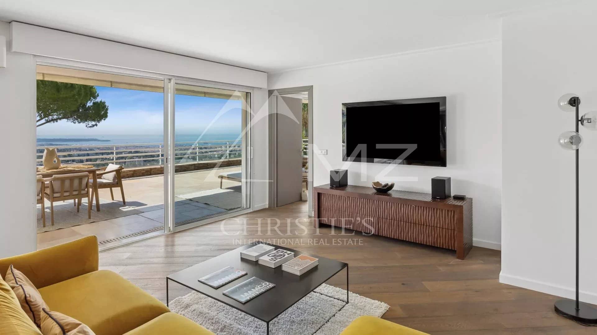 Apartment with panoramic views in Le Cannet Bright living room of an apartment with sea view, terrace and modern furniture.