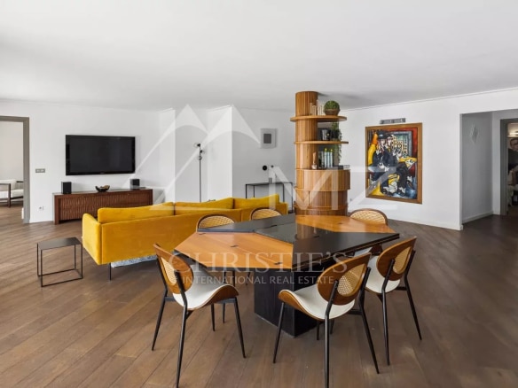 Interior of a modern apartment with living room, dining room and sea view.