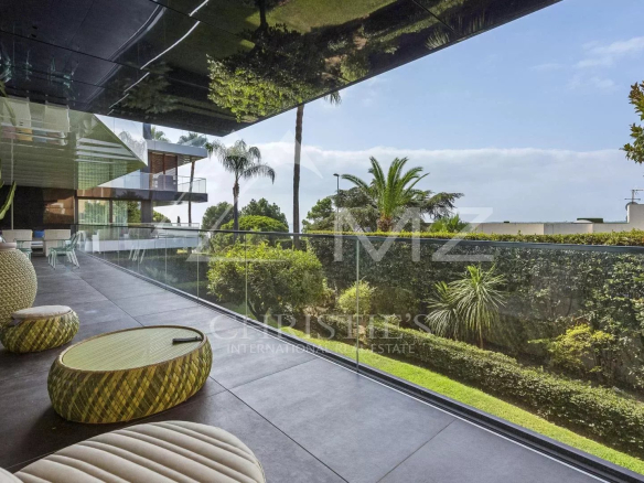 Terrace of a contemporary apartment overlooking a garden in Cannes, Californie district.