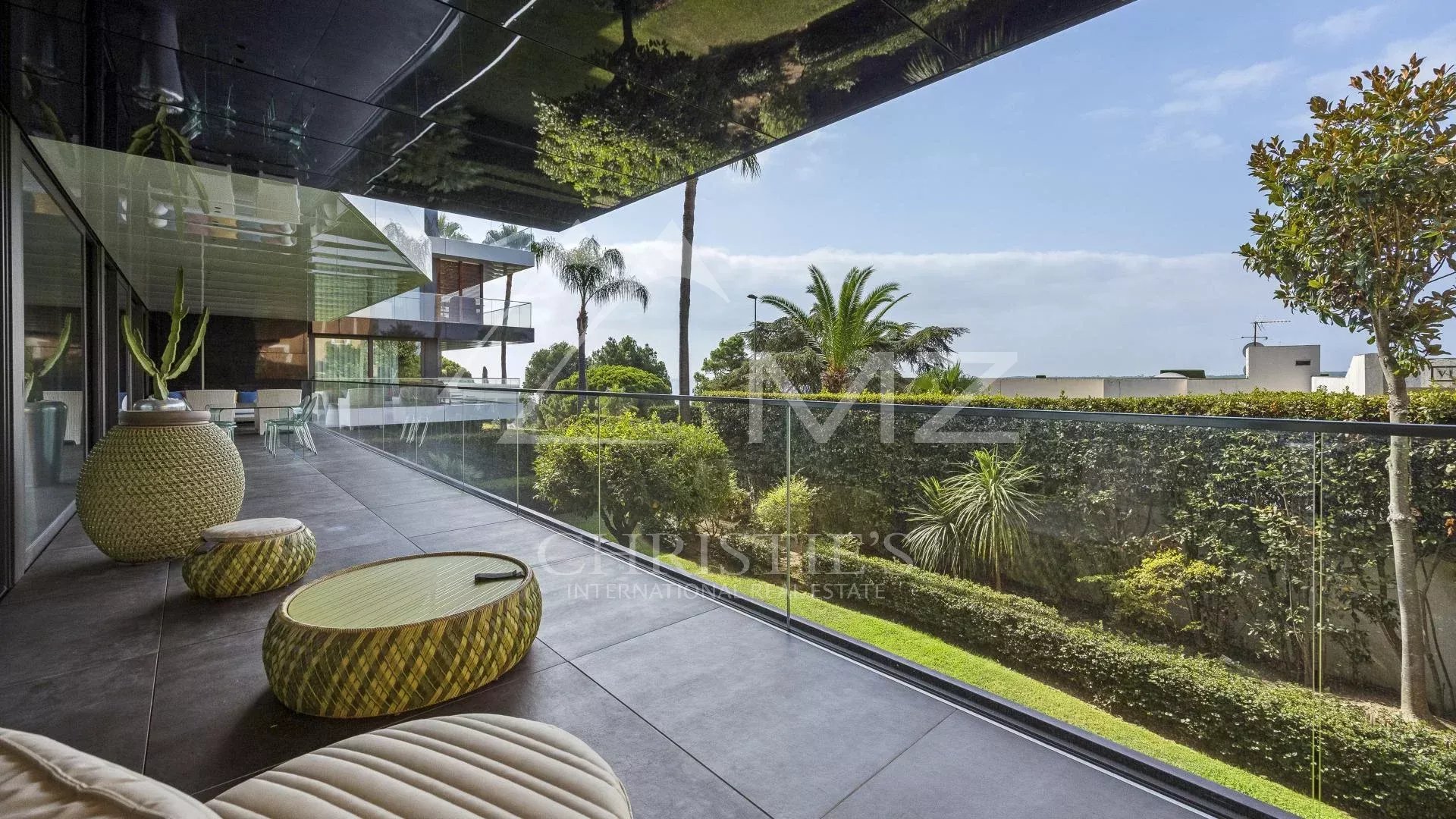 Terrace of a contemporary apartment overlooking a garden in Cannes, Californie district.