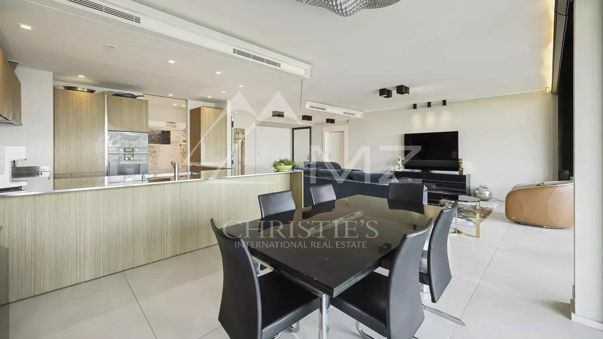 Interior of a contemporary apartment with open kitchen and dining room in Cannes.