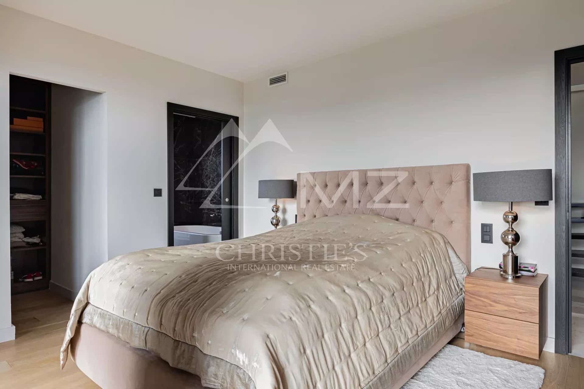Bedroom in a Cannes penthouse with a bed and modern furniture.