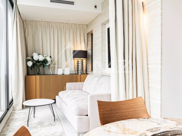 Interior of a penthouse in Cannes with sofa, table and elegant decoration.