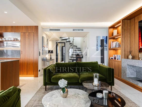 Interior of a modern penthouse with a bright living room and elegant decor.