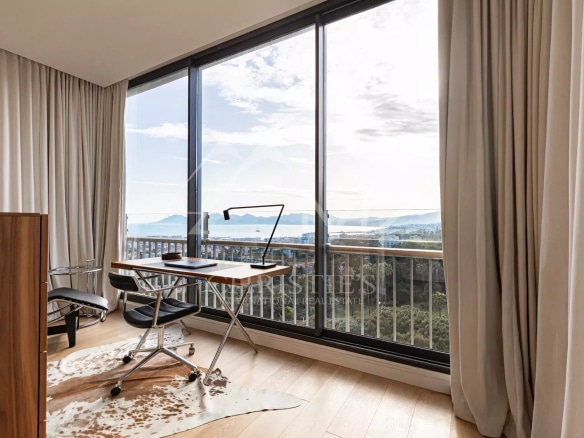 Interior of a penthouse with office and sea view in Cannes.