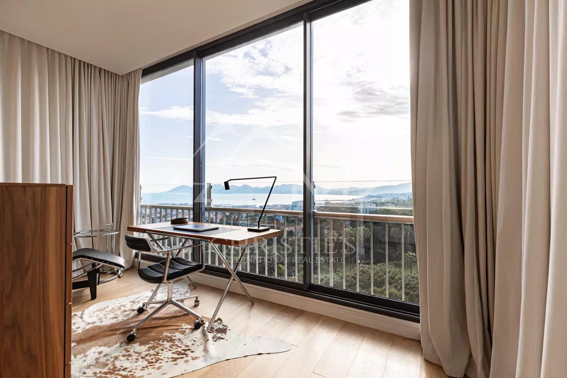 Interior of a penthouse with office and sea view in Cannes.