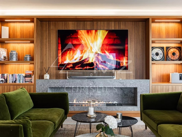 Interior of a penthouse with a modern living room, fireplace and television, Cannes