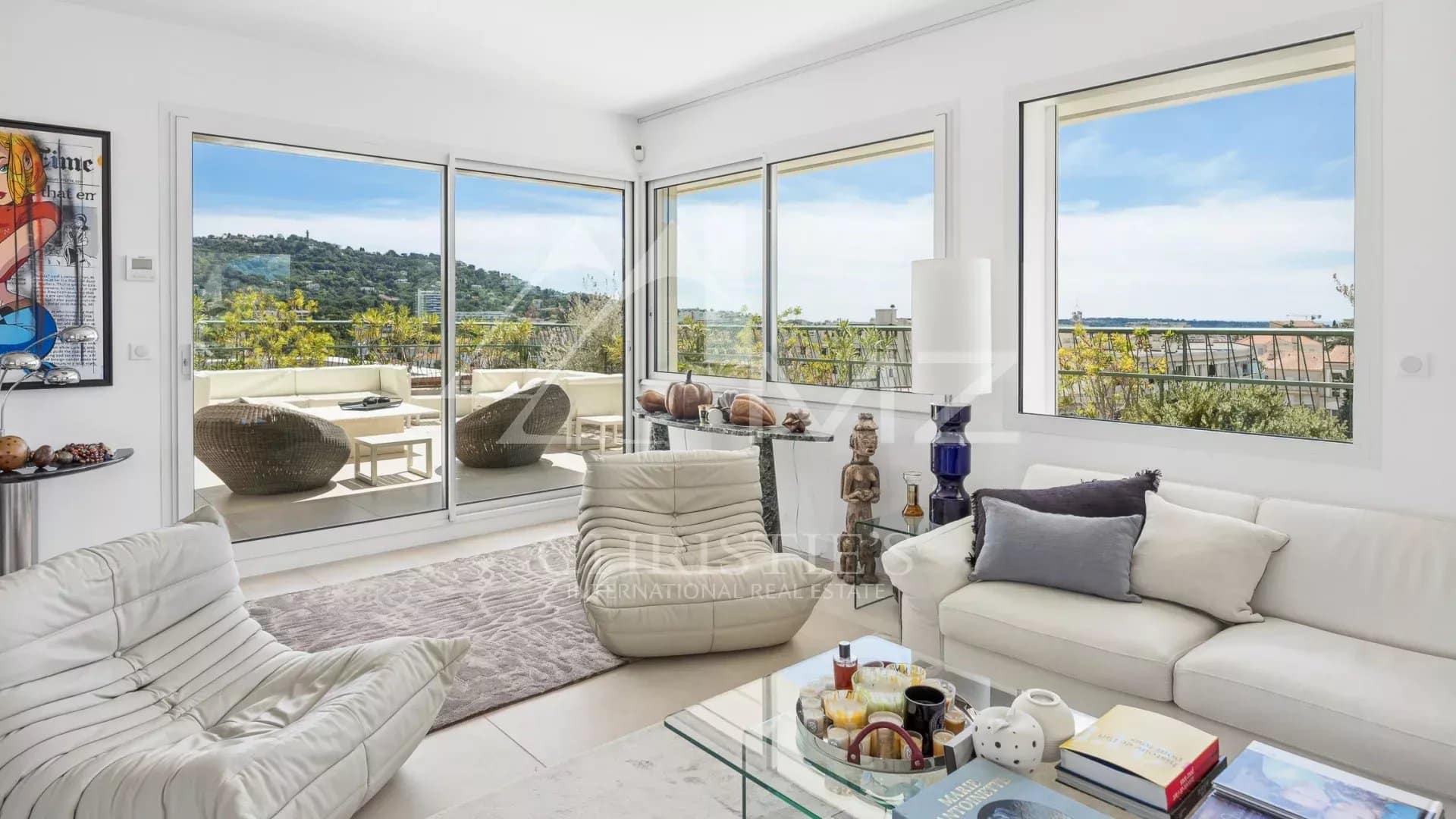 Interior of a rooftop villa in Cannes with views of the hills and the sea.