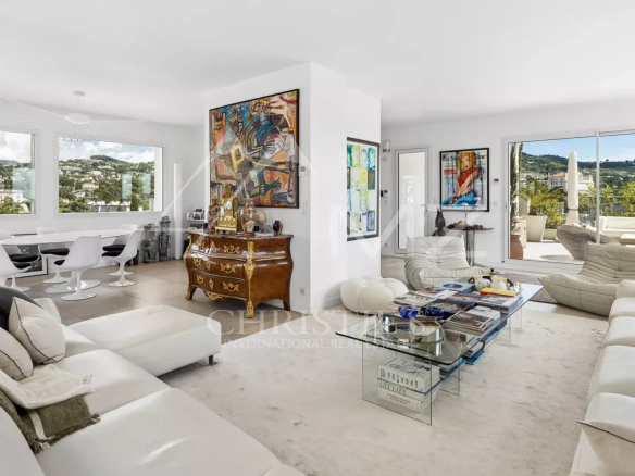Interior of a rooftop villa in Cannes with a modern living room and views of the hills.
