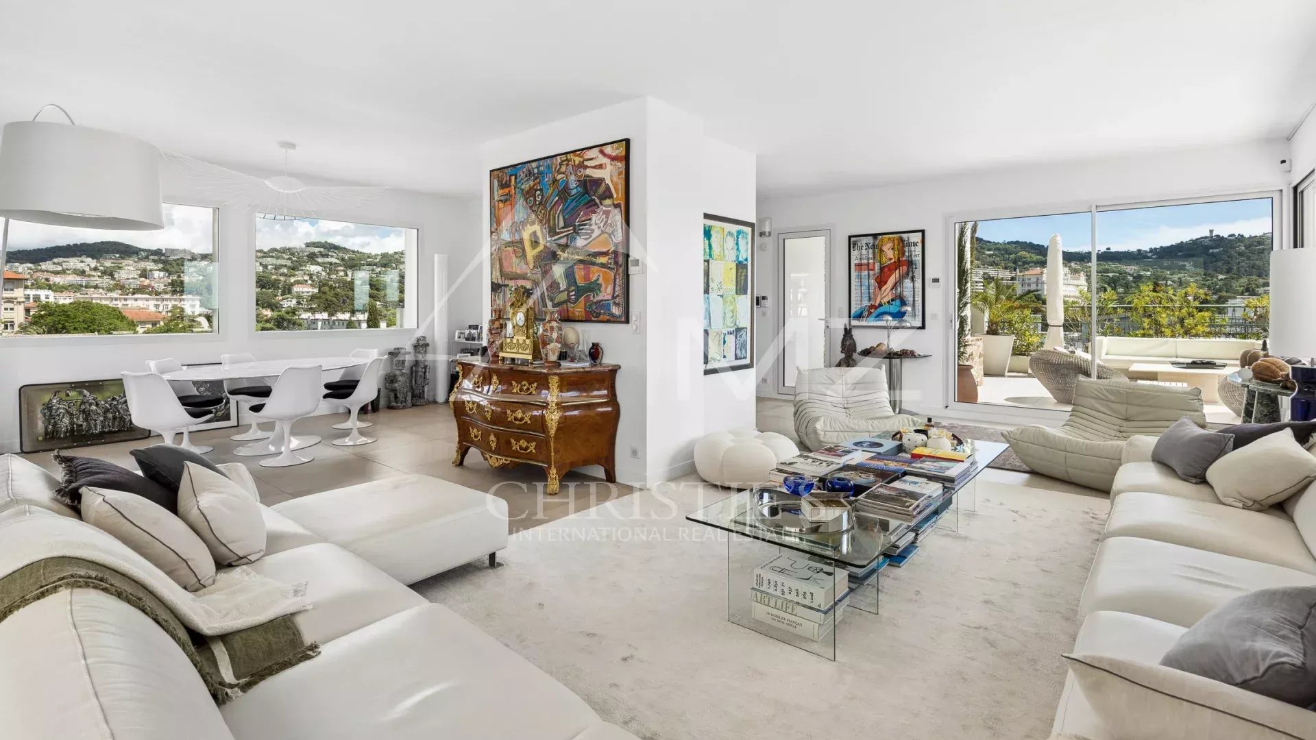 Interior of a rooftop villa in Cannes with a modern living room and views of the hills.