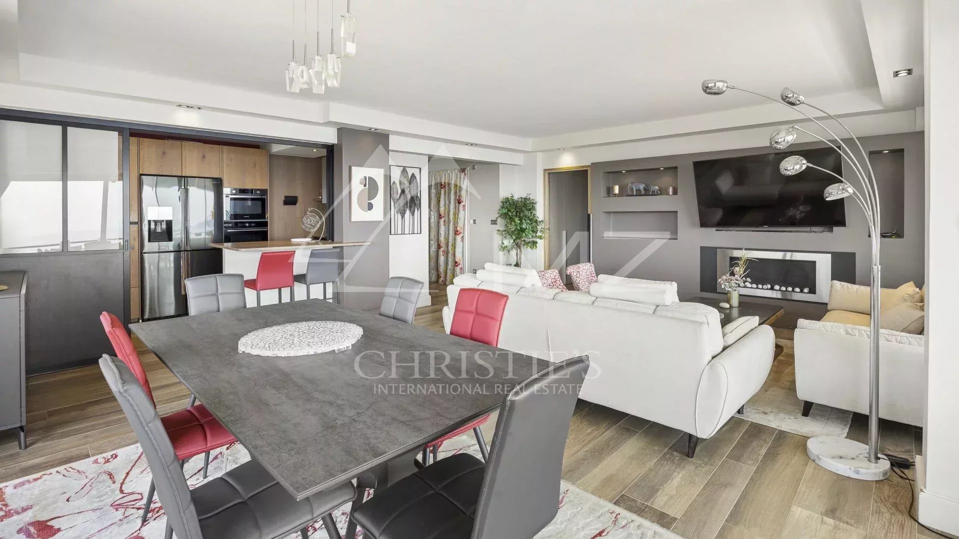 Interior of a modern apartment with living room, dining room and open kitchen in Cannes.