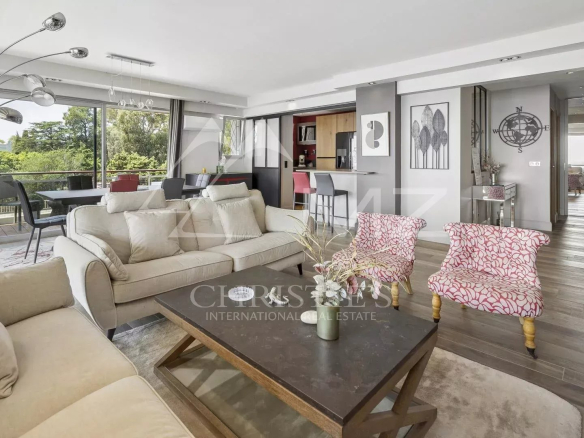 Interior of a modern apartment with a bright living room and open kitchen in Cannes.