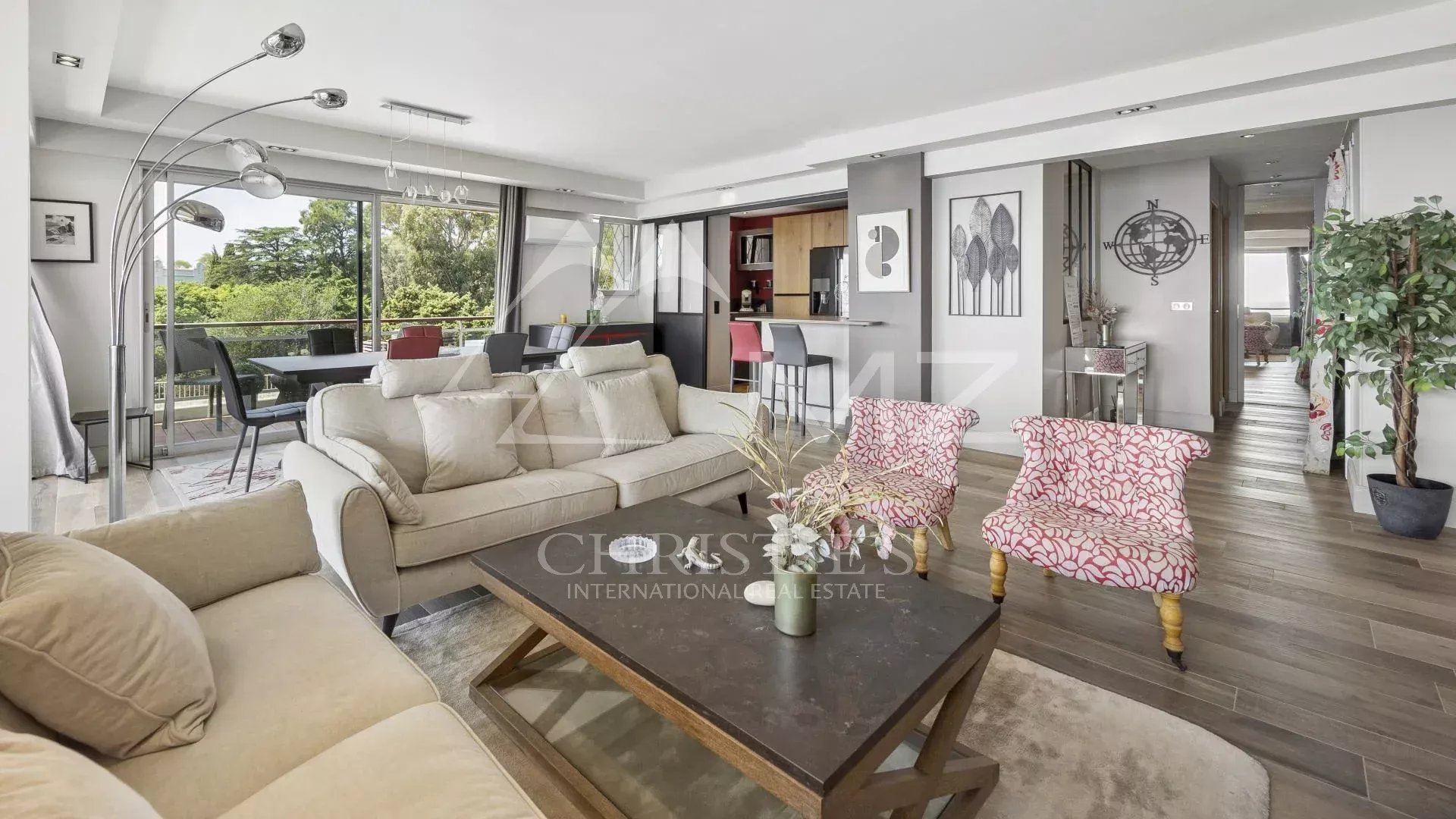 Interior of a modern apartment with a bright living room and open kitchen in Cannes.