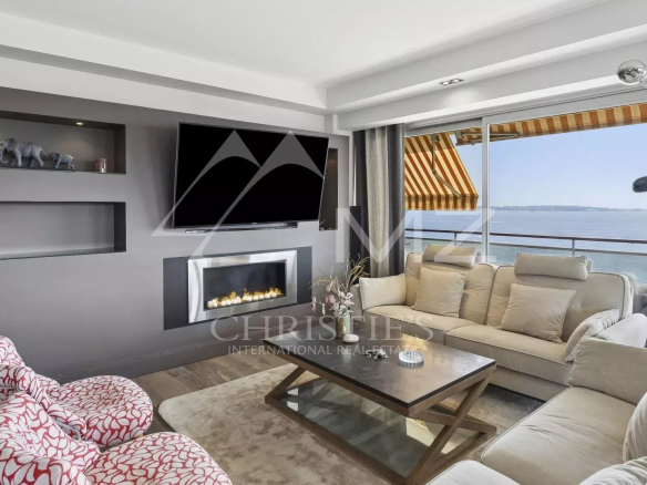 Modern living room with fireplace and sea view, top floor apartment in Cannes.