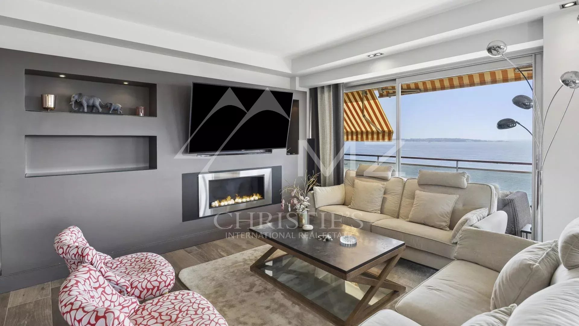 Modern living room with fireplace and sea view, top floor apartment in Cannes.