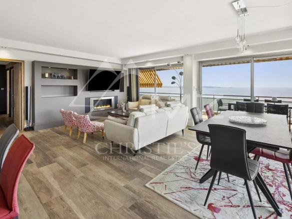Interior of a bright apartment with sea view, modern living room and dining room.