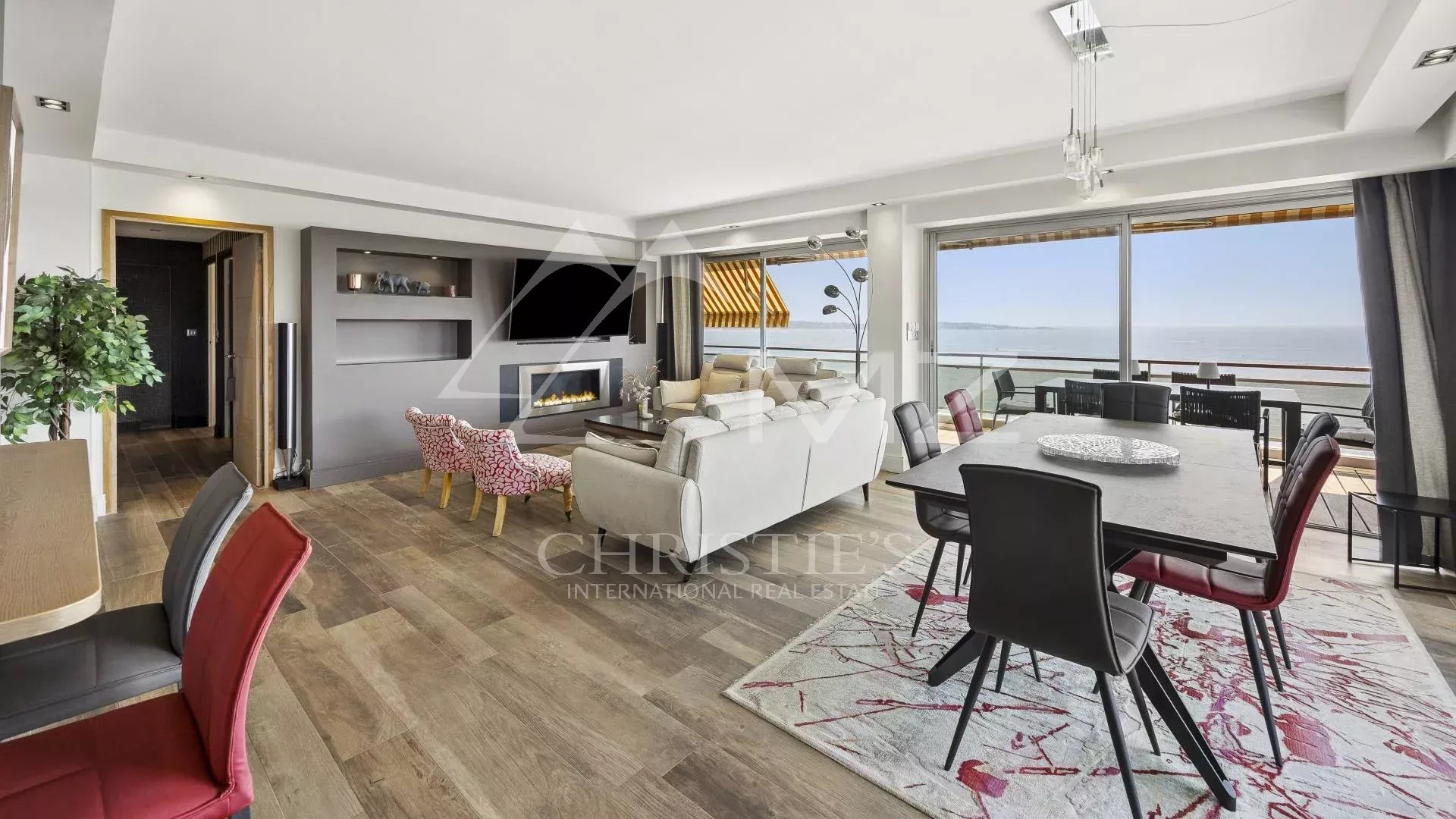 Interior of a bright apartment with sea view, modern living room and dining room.