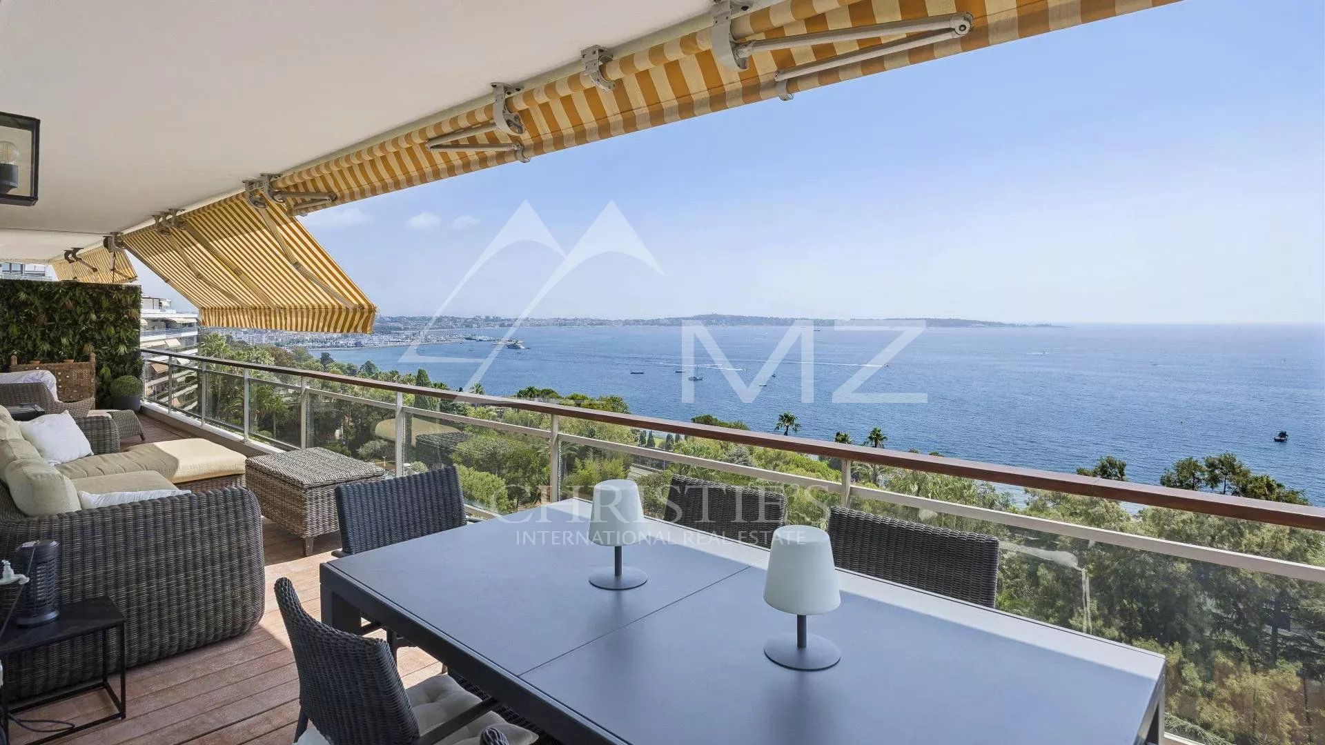 Apartment terrace with sea view in Cannes, garden furniture and parasols
