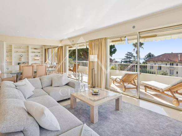 Salon lumineux d'un appartement d'angle à Cannes avec vue sur la mer et terrasse.