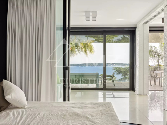 Chambre d'un appartement de luxe à Cannes avec vue sur la mer depuis la terrasse.
