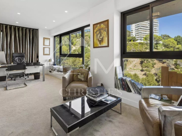 Interior of a contemporary apartment in Cannes with sea view, office and living room.