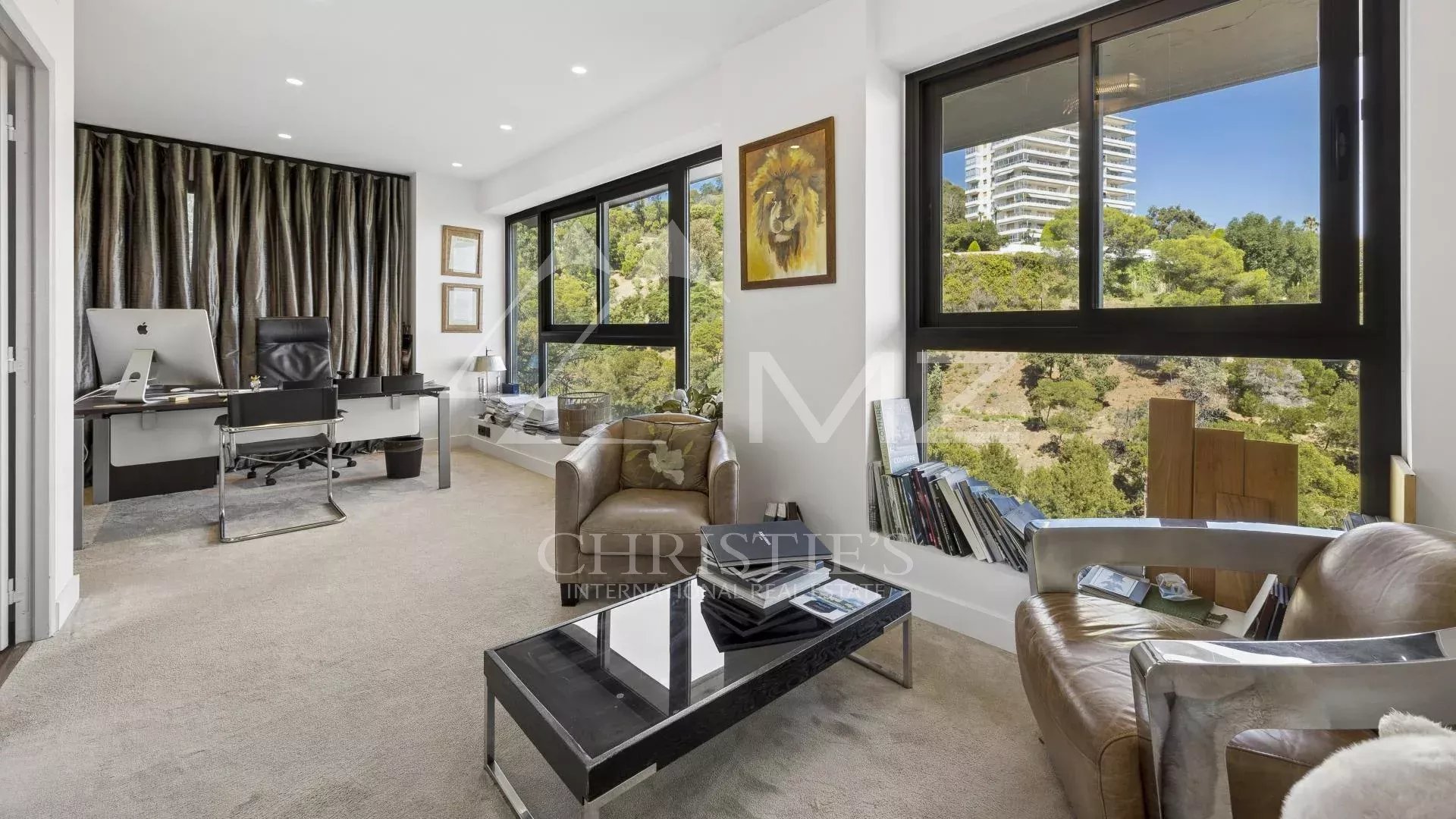 Interior of a contemporary apartment in Cannes with sea view, office and living room.