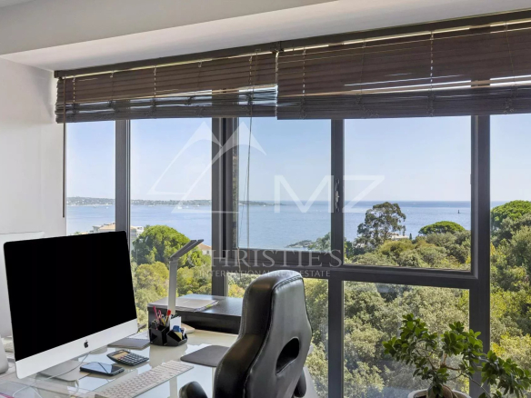Panoramic sea view from a contemporary apartment in Cannes, with a modern office.