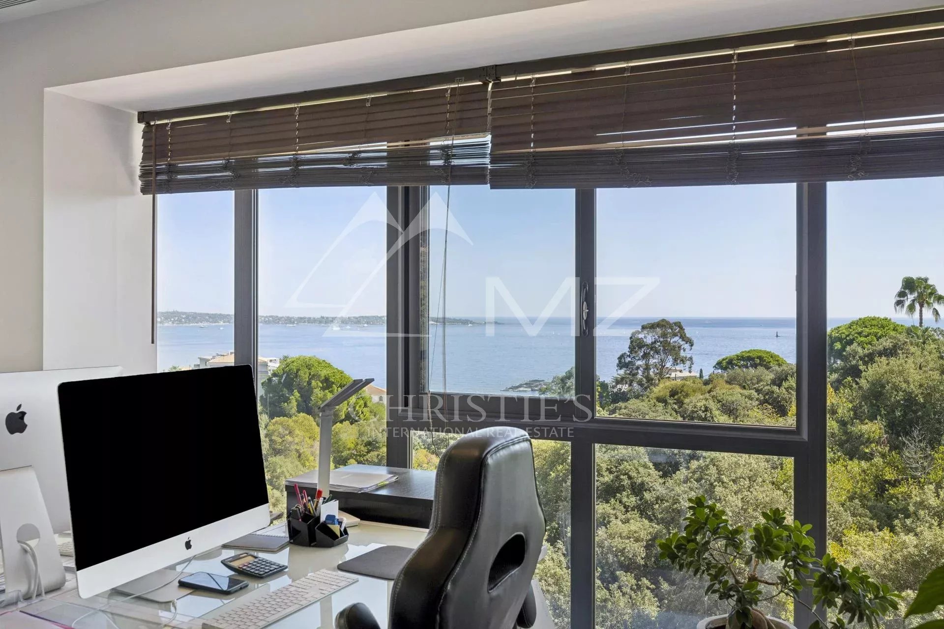 Panoramic sea view from a contemporary apartment in Cannes, with a modern office.