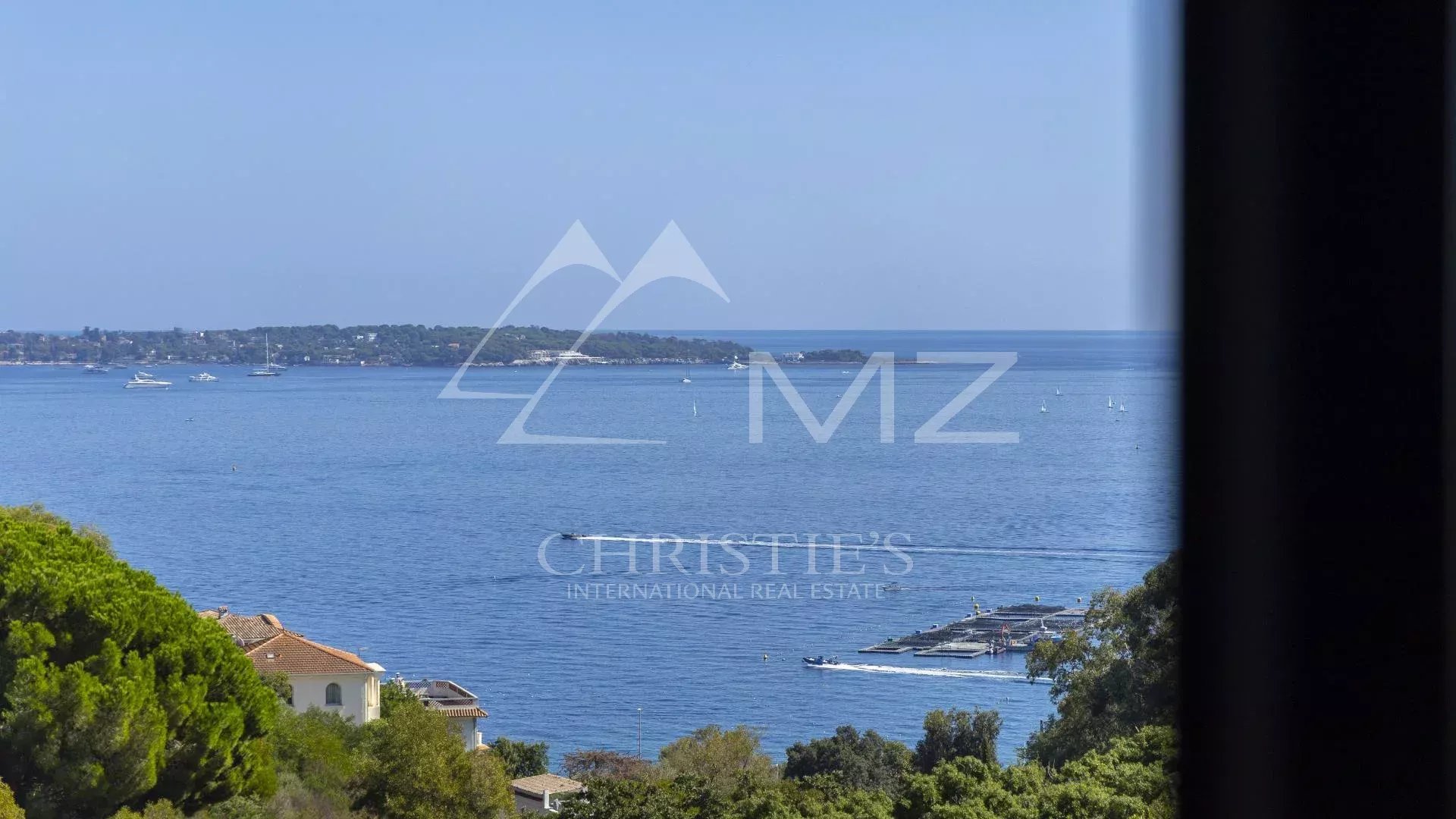 Panoramic sea view from an apartment in Cannes, with boats in the distance.