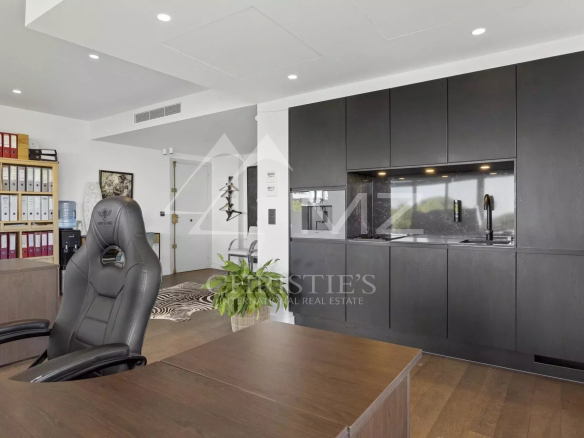 Interior of a contemporary apartment with a modern kitchen and workspace.