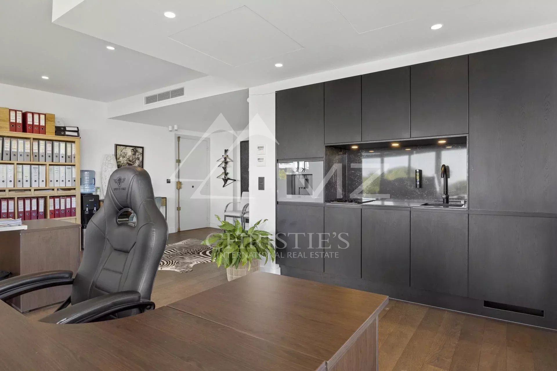 Interior of a contemporary apartment with a modern kitchen and workspace.