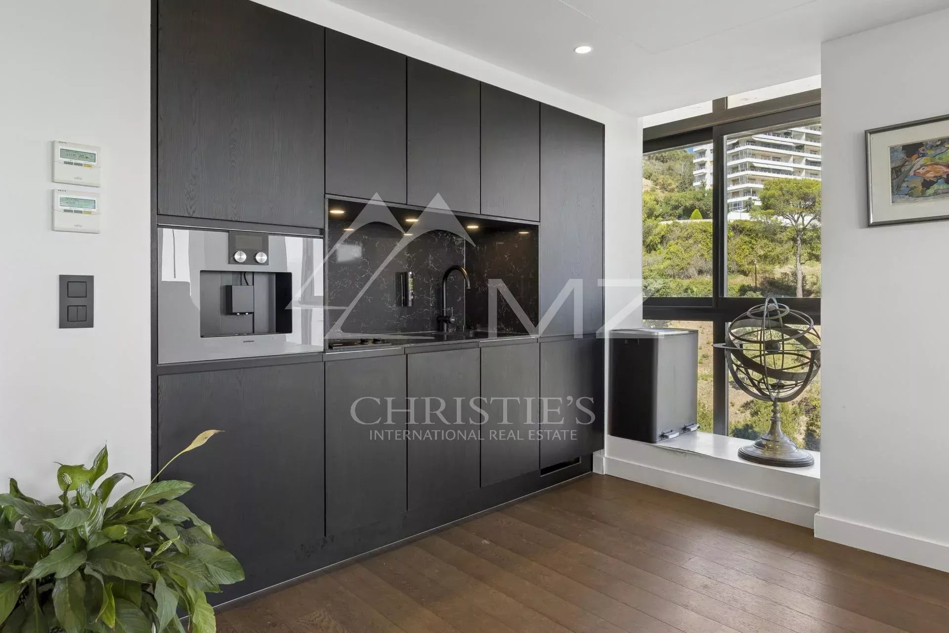 Modern and fully equipped kitchen in a contemporary apartment in Cannes with sea views.