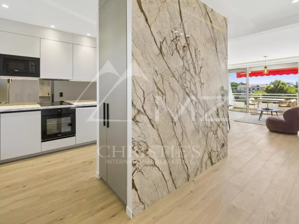 Interior of a renovated apartment in Cannes, with a modern kitchen and bright living room