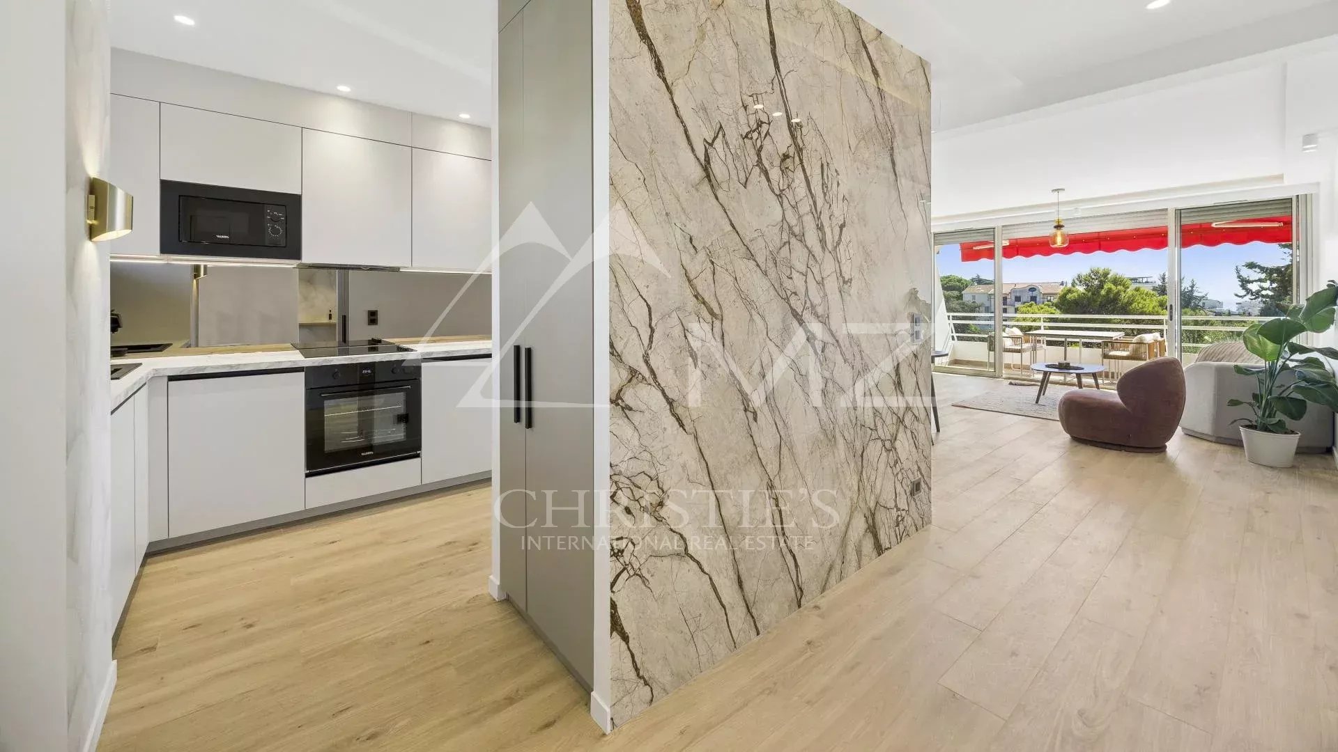 Interior of a renovated apartment in Cannes, with a modern kitchen and bright living room