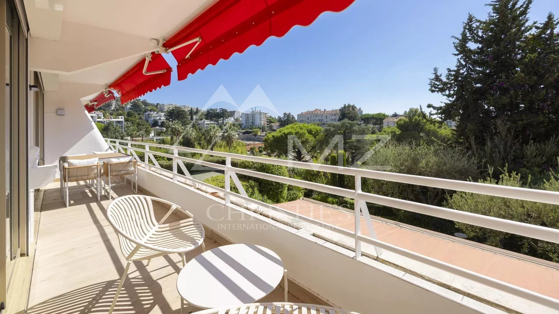 Apartment terrace in Cannes with unobstructed views and outdoor furniture.