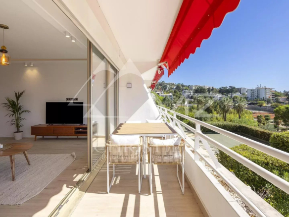 Terrace of a renovated apartment in Cannes with unobstructed views and a glimpse of the sea.