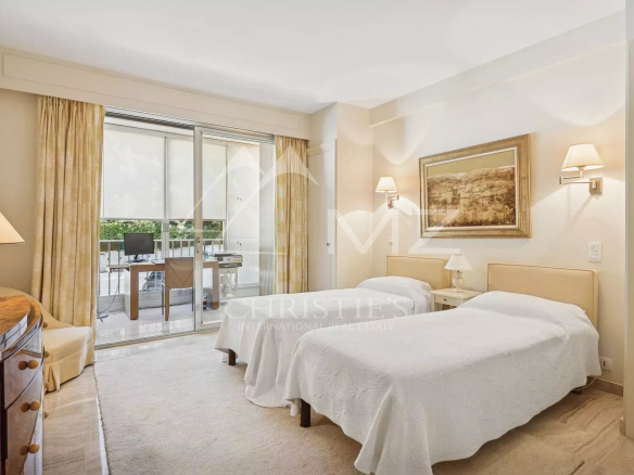 Room in a contemporary apartment in Cannes with access to a terrace.