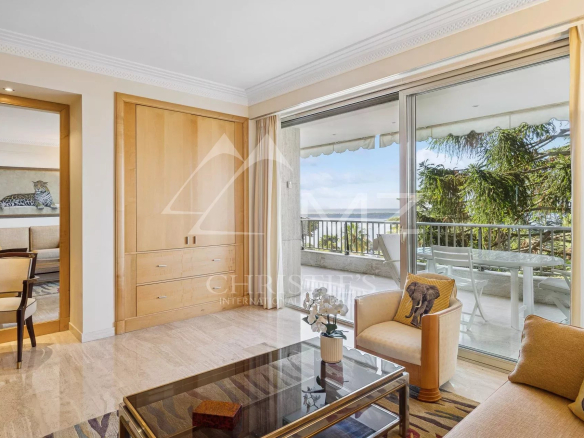Interior of a contemporary apartment in Cannes with sea view, bright living room and terrace.