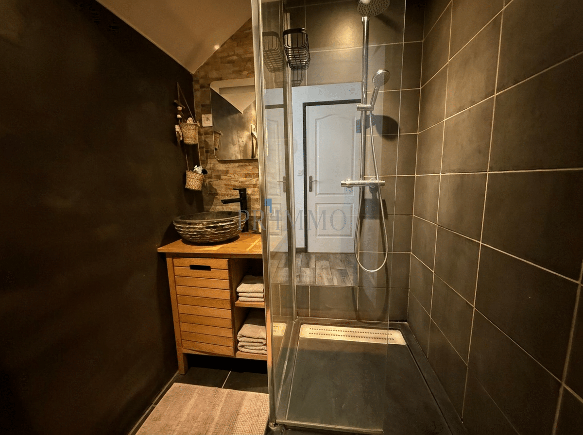 Bathroom with modern shower Modern bathroom with walk-in shower and wooden vanity.