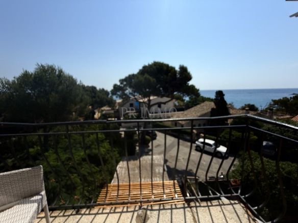 View from a balcony overlooking a street leading to the beach in Roquebrune-sur-Argens.