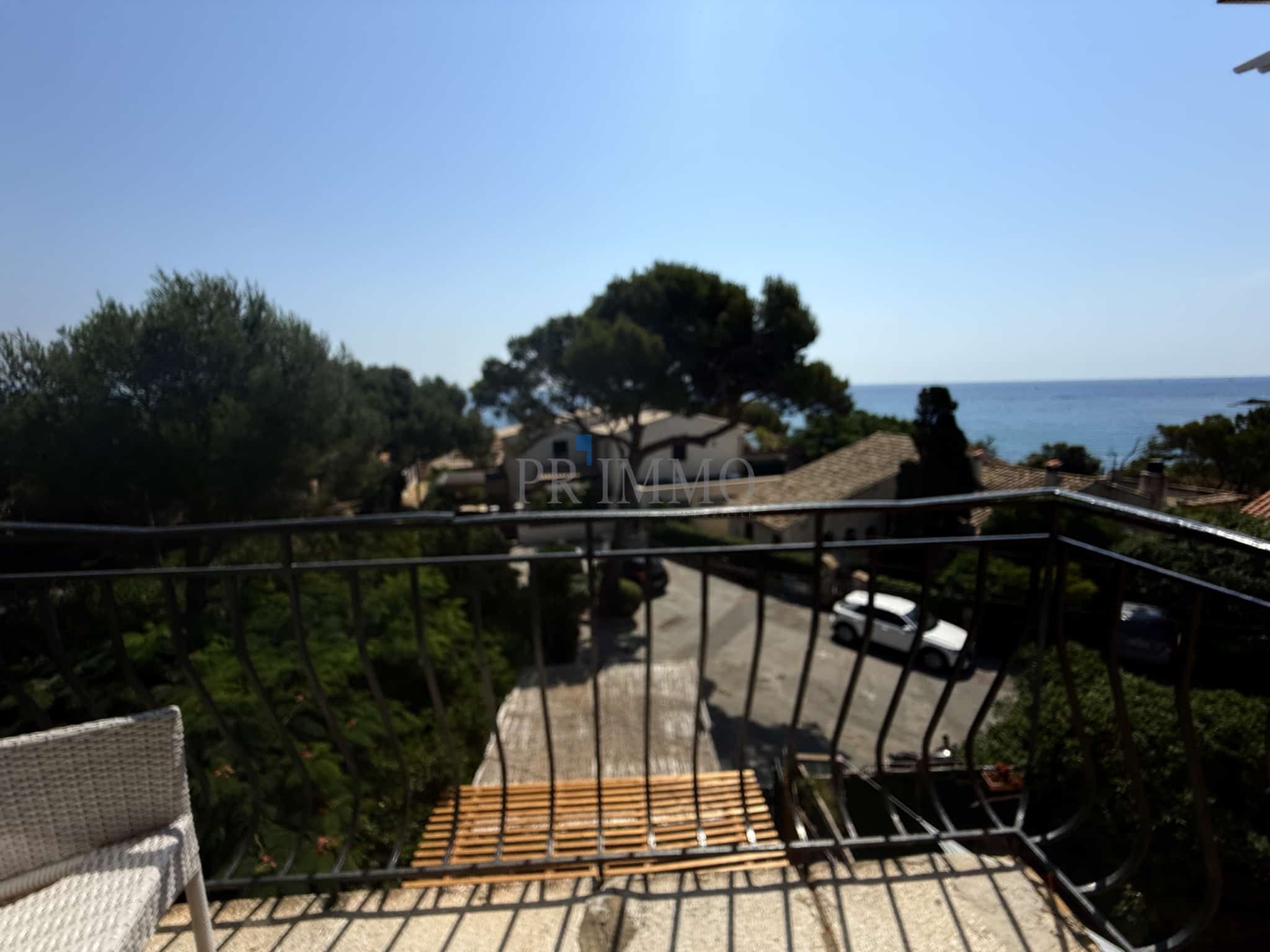 Beach view from a balcony View from a balcony overlooking a street leading to the beach in Roquebrune-sur-Argens.