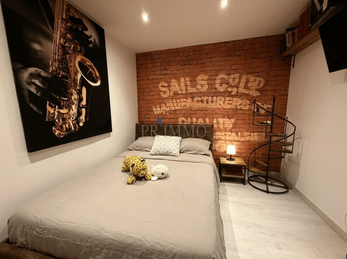 Attic room in Roquebrune-sur-Argens Attic room with double bed and brick wall decoration.