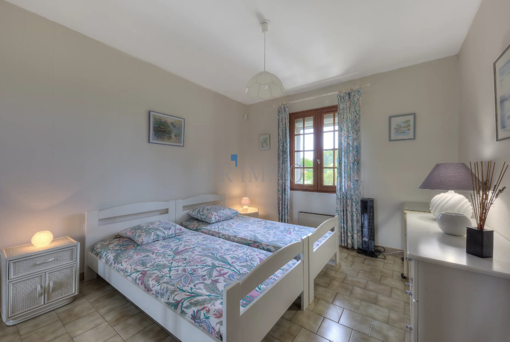 Bright room with twin beds and simple decor.