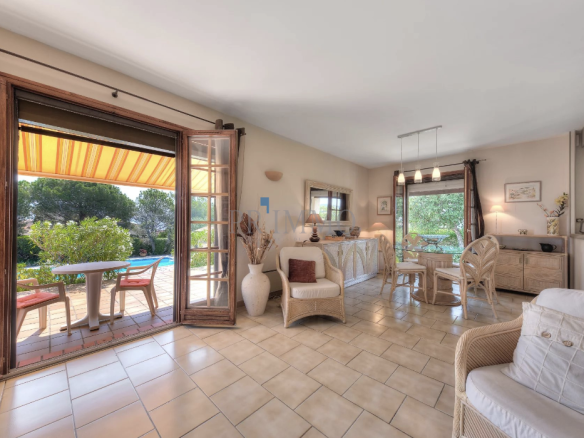 Interior of a single-storey villa with sea view, bright living room and garden